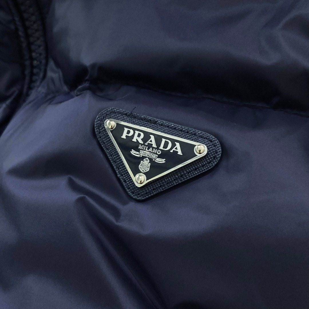 Prada Quilted Triangle Badge Puffer Jacket — detail