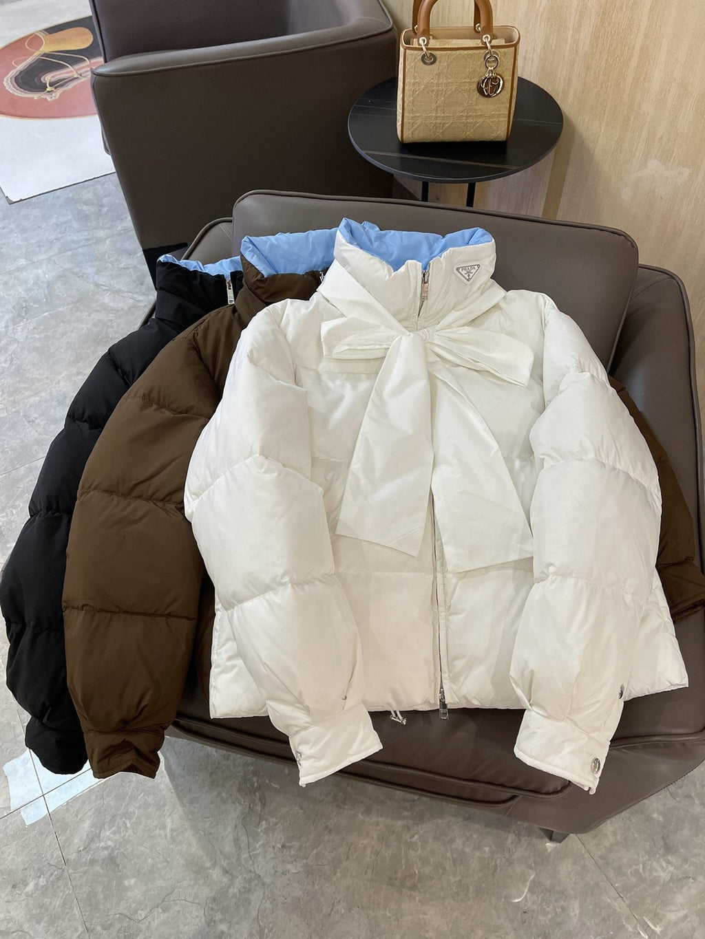 Prada Reversible Cropped Puffer Jacket with Removable Bow Scarf — comparison